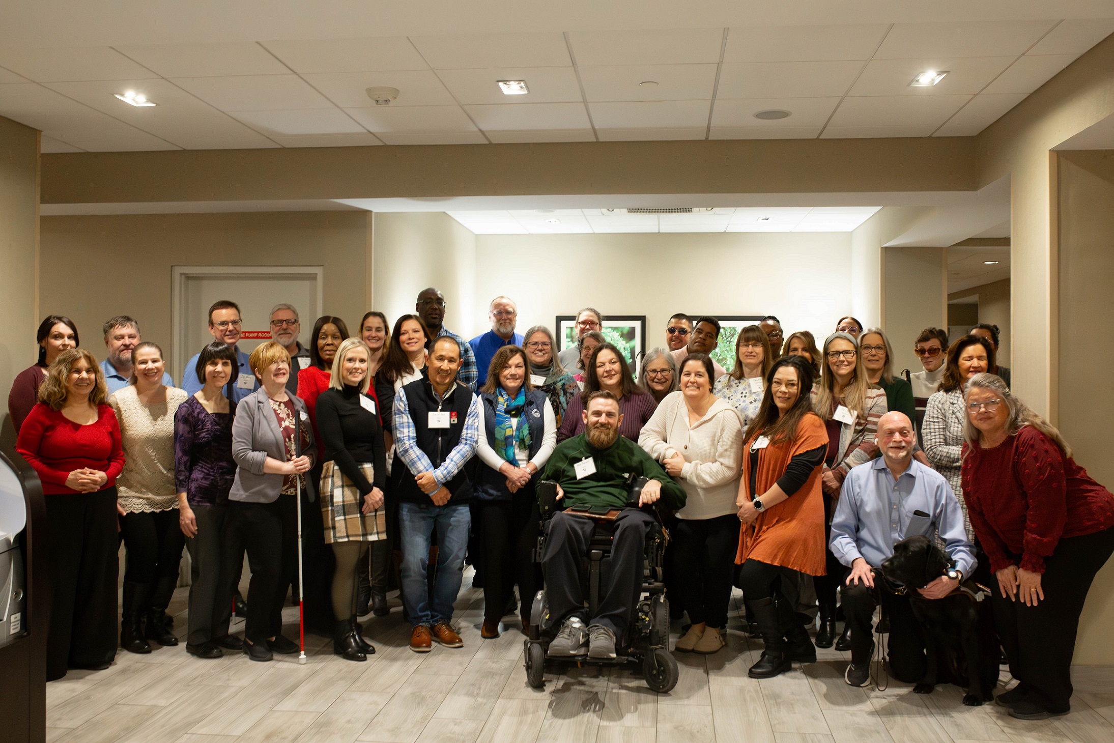 Group photo of OIB-TAC attendees standing together smiling.