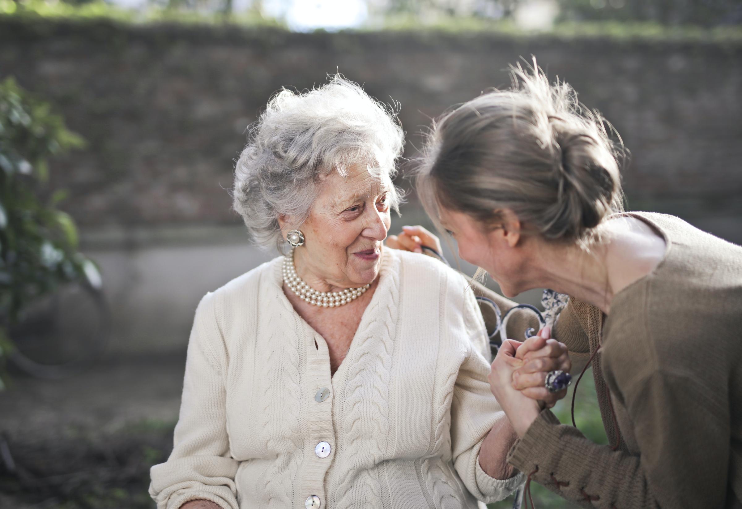 Mother and daughter sitting on a bench 