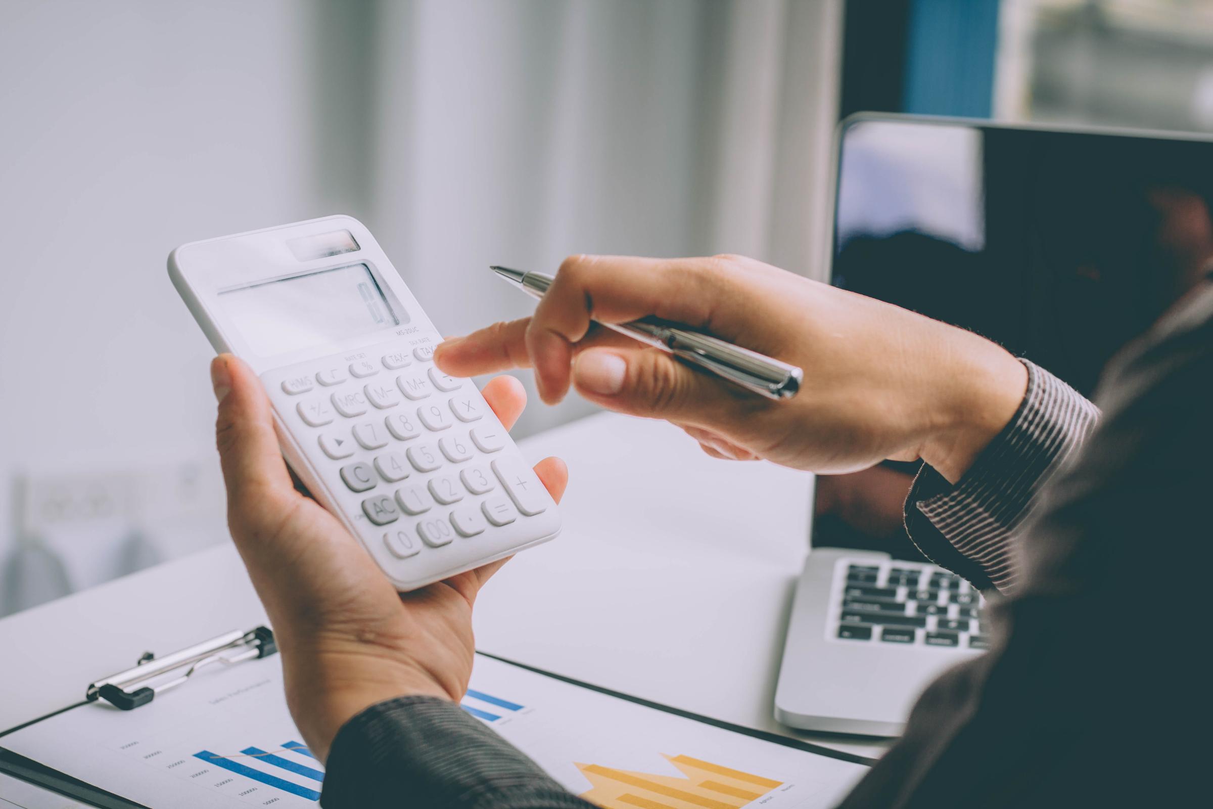 Hands holding a calculator.