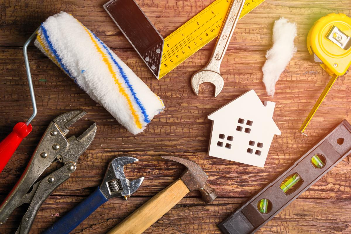 Home maintenance tools on a wooden table.